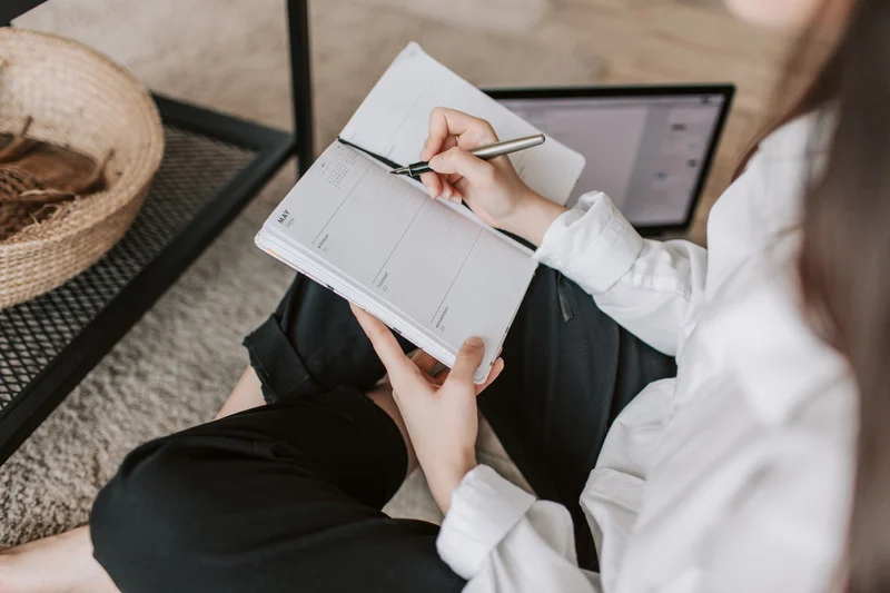 Person writing in an event planner