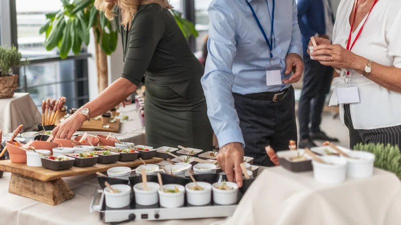 man and woman preparring food for a corportate event