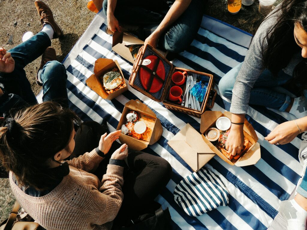 Friends and family gathering for a picnic on the beach